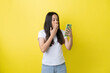 © torwaiphoto - A woman is surprised to see something on her phone.