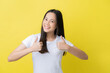 © torwaiphoto - Woman feeling happy, doing thumbs up gesture