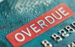 © Chopang.studio - A close-up of a credit card displaying the word 'OVERDUE' in bold red letters, indicating a missed payment or overdue balance.