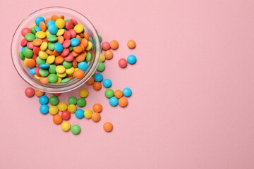 Wall Mural - Tasty candies in bowl on pink background, top view. Space for text