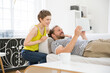 © Westend61 - Happy young couple with tablet in living room at home