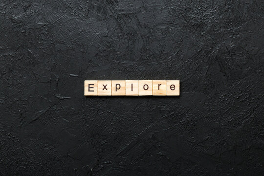 Explore word written on wood block. Explore text on cement table for your desing, concept