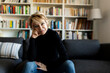 © Westend61 - Portrait of mature woman sitting on couch at home