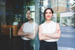 © Westend61 - Portrait of confident young businesswoman reflected in glass front, Berlin, Germany