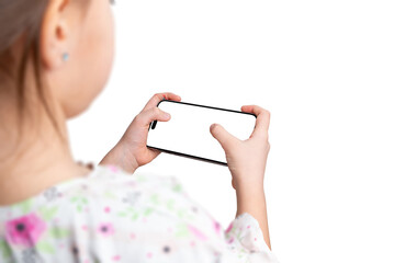 Aufkleber - Young girl holds a smartphone horizontally, playing a game or using an app. Over the shoulder view, isolated display and background for mockup.