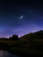 Wall Mural - new moon in the evening sky. dreamy landscape with moon and stars over green hills.