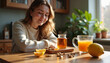 © Vera - A cheerful woman sits in her kitchen, enjoying a cup of tea with honey, a natural remedy for spring flu and cold symptoms.