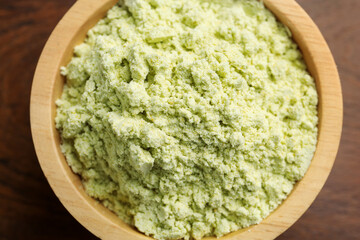 Wall Mural - Dry wasabi powder in bowl on wooden table, top view