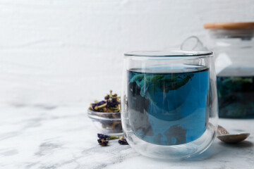 Wall Mural - Delicious butterfly pea flower tea on white marble table. Space for text