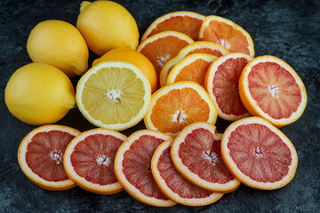 Wall Mural - Bright composition with oranges, lemons and grapefruits cut into slices