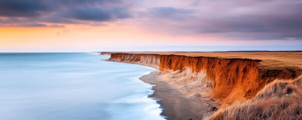 Poster - Weathering process idea. Stunning sunset over a coastal cliff, blending colors of sky and sea in tranquil harmony.