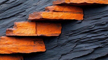 Aufkleber - Weathering process concept. Close-up of unique orange stone steps against dark slate background.