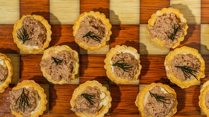 Sticker - Tartlets with liver pate and a wooden chessboard.