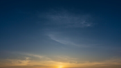 Wall Mural - blue sky with soft wispy clouds at sunrise