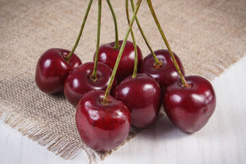 Wall Mural - Fresh ripe cherries on jute cloth. Healthy dessert or snack