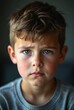 © Michael - Portrait of sad young boy with blue eyes frowning in studio