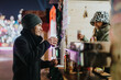 © qunica.com - Two friends smiling and enjoying hot drinks at a seasonal market on a chilly evening.