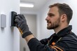 © Milos - An experienced technician is focused on installing a modern smart switch on a clean wall, showcasing attention to detail in electrical work and home improvement.
