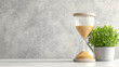 © MAKASIHMAS SIDNEY - Hourglass, plant, time management, office desk, background