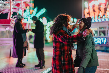 Poster - Friends gather and have fun at a lively night carnival filled with bright lights, attractions, and a joyous atmosphere, creating memories of togetherness in this vibrant setting.