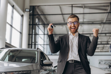 Wall Mural - Yes, that's my new car! Customer in car dealership. Happy bearded man new car owner with keys in hand