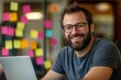 © pixeness - Happy man working on laptop with sticky notes