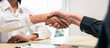 © Freedomz - Two people shaking hands in a business meeting