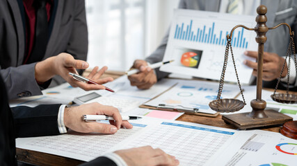 Aufkleber - Three people are sitting at a table with papers and pens