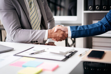 Poster - A man shakes hands with another man in a business setting