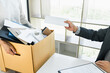 © Freedomz - Hand of employer filing final remuneration after employee to write a document letter of resignation, resign concept