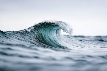 Poster - A large ocean wave crashing in the middle of the sea, with blue waters and sunlight reflecting off the surface