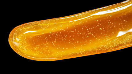 Poster - Glowing honey droplets floating against a dark background for natural aroma concepts