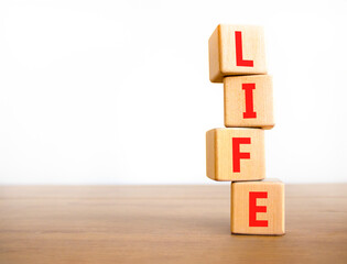 Life symbol. Concept word Life on beautiful wooden blocks. Beautiful wooden table white background. Business, lifestyle, support and life concept. Copy space.