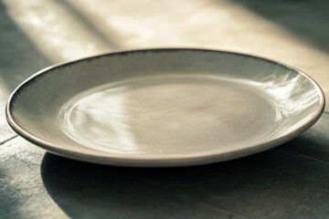 Sticker - A simple white plate sits on a table, ready for use