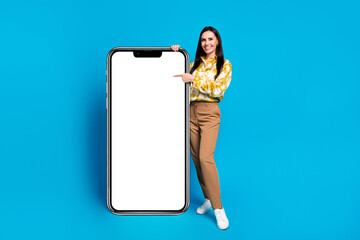 Poster - Photo of glamour lovely woman wear trendy clothes presenting novelty mockup empty space isolated on blue color background