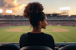 © jr-art - A woman with a ponytail is sitting in a stadium seat