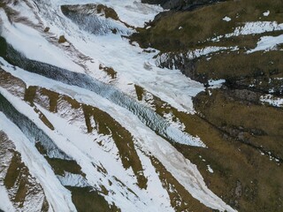 Wall Mural - mountain range texture, snow and stones top view, aerial view