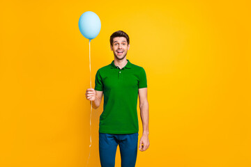 Poster - Portrait of his he nice attractive cheerful cheery glad guy holding in hand air ball having fun isolated over bright vivid shine vibrant yellow color background