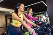 © Mediteraneo - Two women ride a bicycle in the gym.