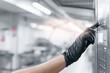 © Parilov - Gloved hand worker operating machine control panel in modern bakery factory setting
