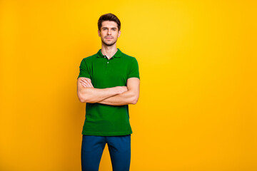 Poster - Photo of white serious confident clever man standing with hands folded wearing trousers pants blue isolated over yellow vibrant color background