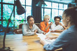 © oneinchpunch - cinematic image of people working in a start up business.