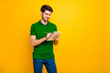 Poster - Portrait of his he nice attractive cheerful cheery focused concentrated guy making writing notes memo isolated over bright vivid shine vibrant yellow color background