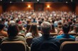 © Vadym - Full lecture hall with people sitting. Students attending seminar, business training, conference. Large indoor meeting, educational event. Audience listening to speaker presentation. Knowledge