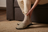 Woman dealing with ankle pain.