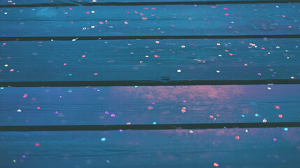 Poster - Colorful confetti gradient on wooden surface for festive background and event decoration