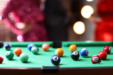 Wall Mural - Many colorful billiard balls on green table indoors, closeup. Space for text