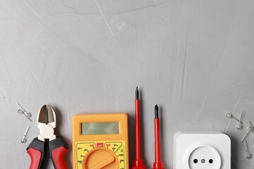 Poster - Different electrical tools on grey table, flat lay. Space for text