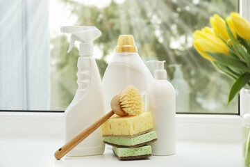 Wall Mural - Spring cleaning. Detergents, supplies and tulips on windowsill indoors