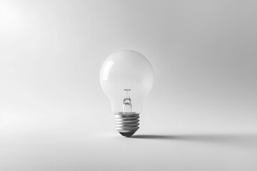 Wall Mural - a single, clear light bulb sits on a plain white background, symbolizing ideas and innovation.